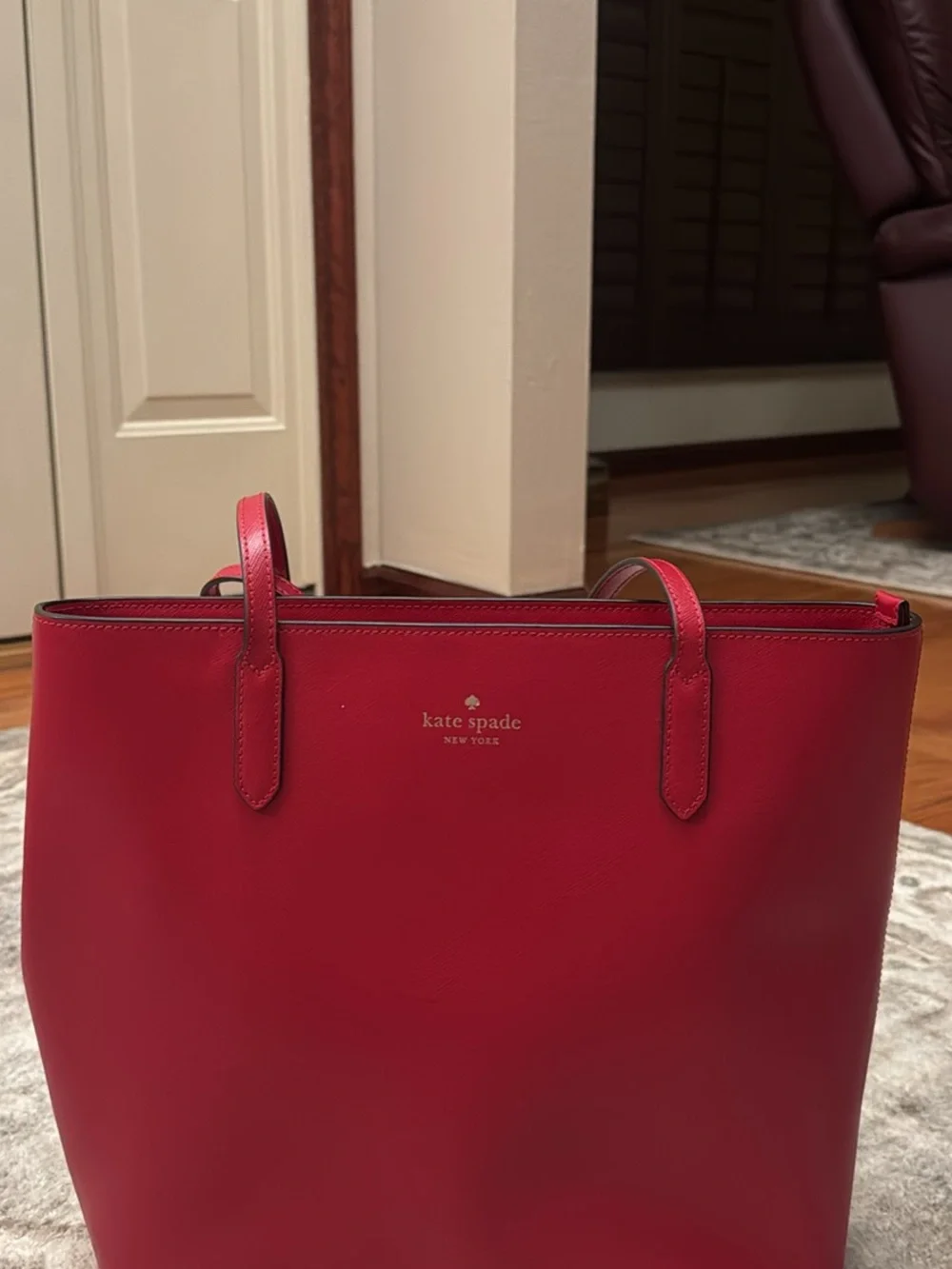 kate spade red Saffiano leather tote with tassel charm